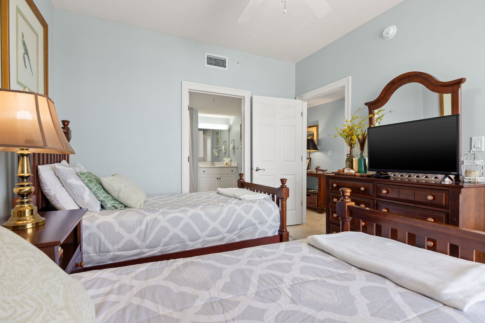Drift into restful sleep in your tranquil retreat, complete with two plush beds, elegant wood furnishings, and an ensuite bathroom just steps away.