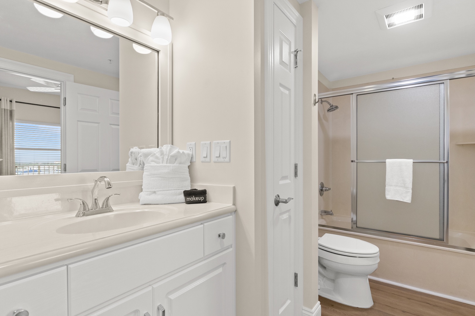 Step into your pristine bathroom with marble counters, crisp white linens, and a spacious shower to refresh after your adventures.