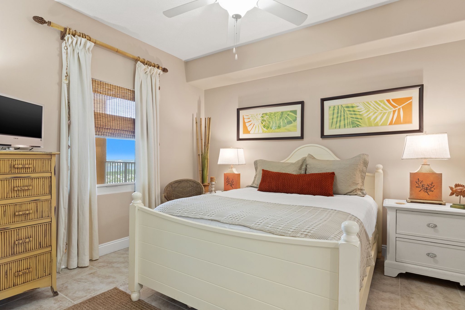 Wake up in your coastal retreat with tropical art above your bed and soft light filtering through bamboo shades. Your private space blends beachy charm with modern comforts for ultimate relaxation.