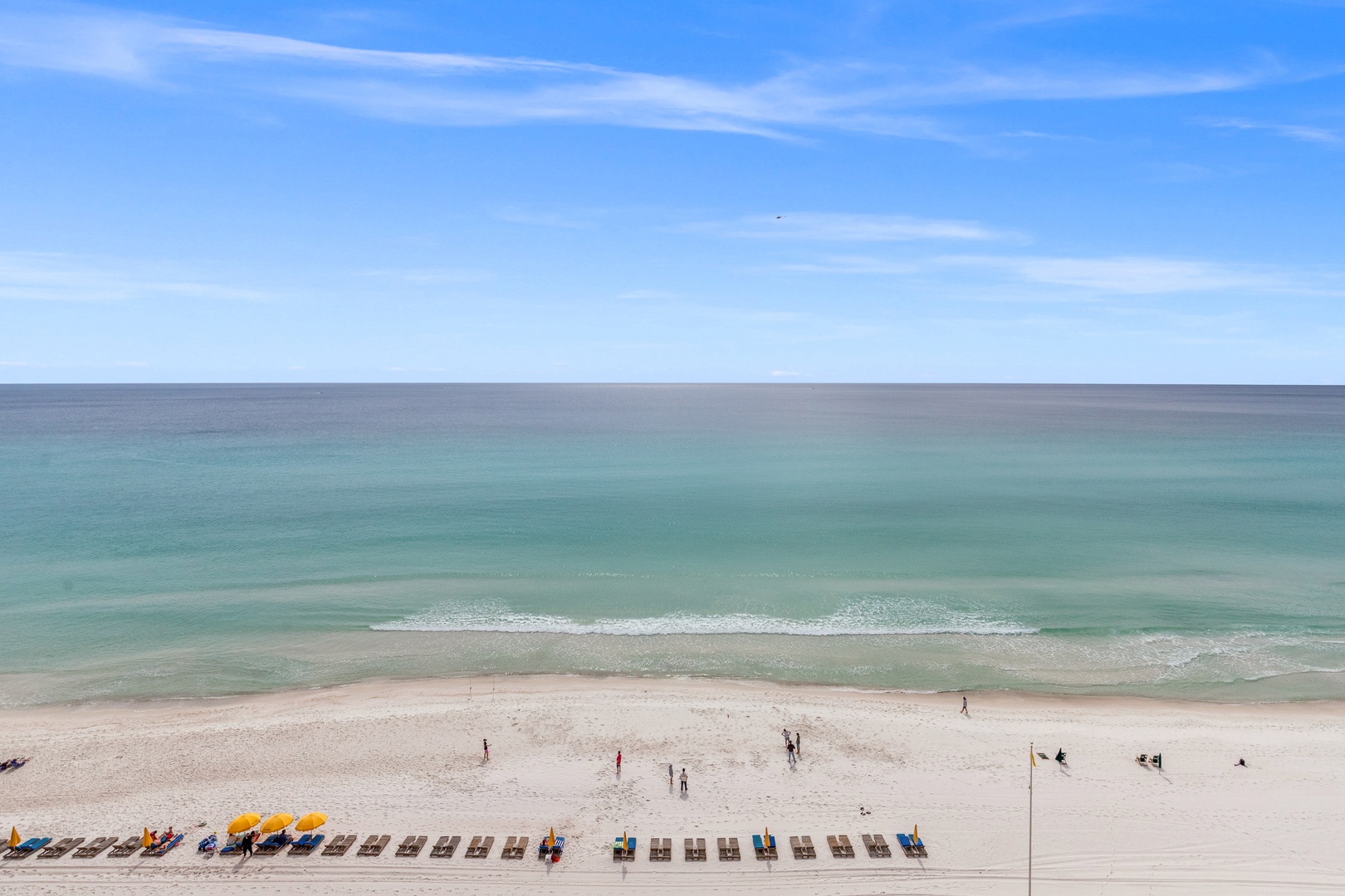 Pristine beachfront with turquoise waters, white sand, and colorful umbrots creating the perfect coastal getaway setting.