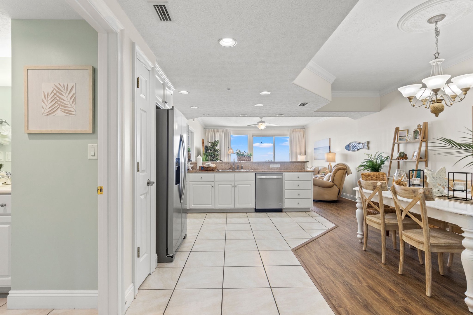 Step into your home away from home, where coastal charm meets comfort. The spacious kitchen flows into a bright dining and living area—perfect for sharing meals and making memories together.