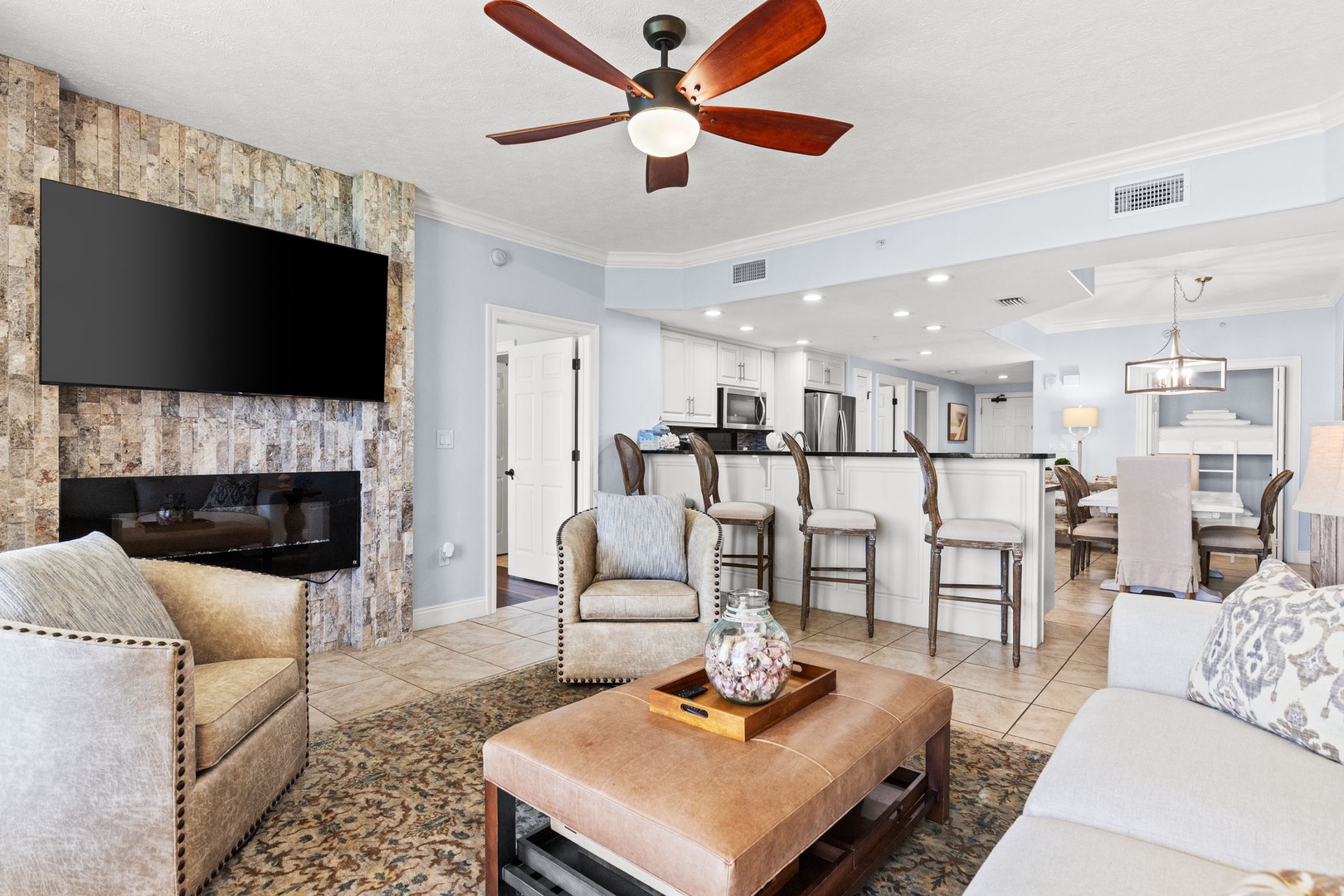 You'll love unwinding in this inviting open living space, where a cozy fireplace, stylish seating, and thoughtful touches blend seamlessly with the bright kitchen and dining area, perfect for gathering.