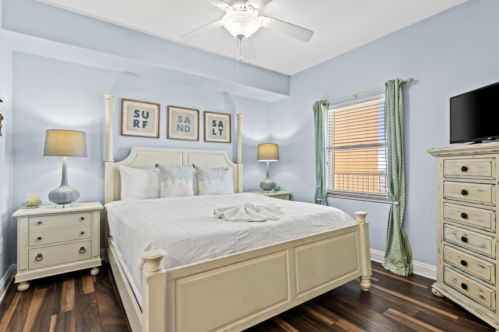 Drift off in your peaceful coastal retreat with soft beach-inspired hues, crisp linens, and gentle breezes from your ceiling fan welcoming you to total relaxation.