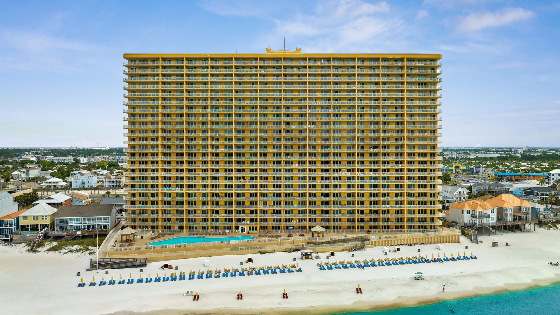 Towering beachfront resort with pristine white sand beach and crystal-clear turquoise waters at your doorstep.