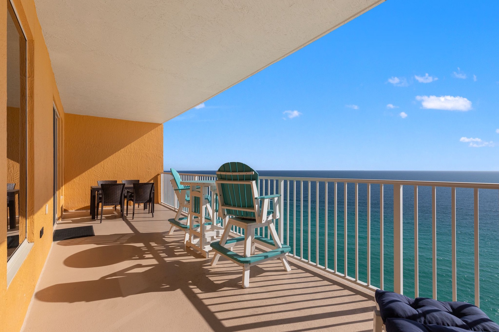 Relax on your private oceanfront balcony with stunning sea views, comfortable seating, and endless turquoise waters stretching to the horizon.