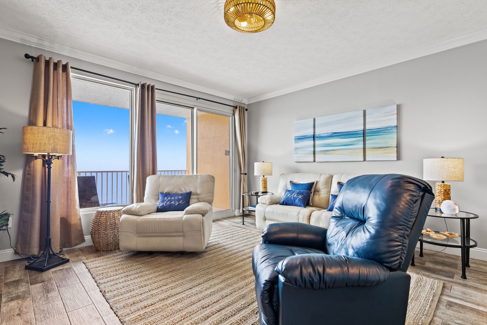 Sink into plush recliners and soak up ocean views through your private balcony—your perfect spot to relax after a beach day.