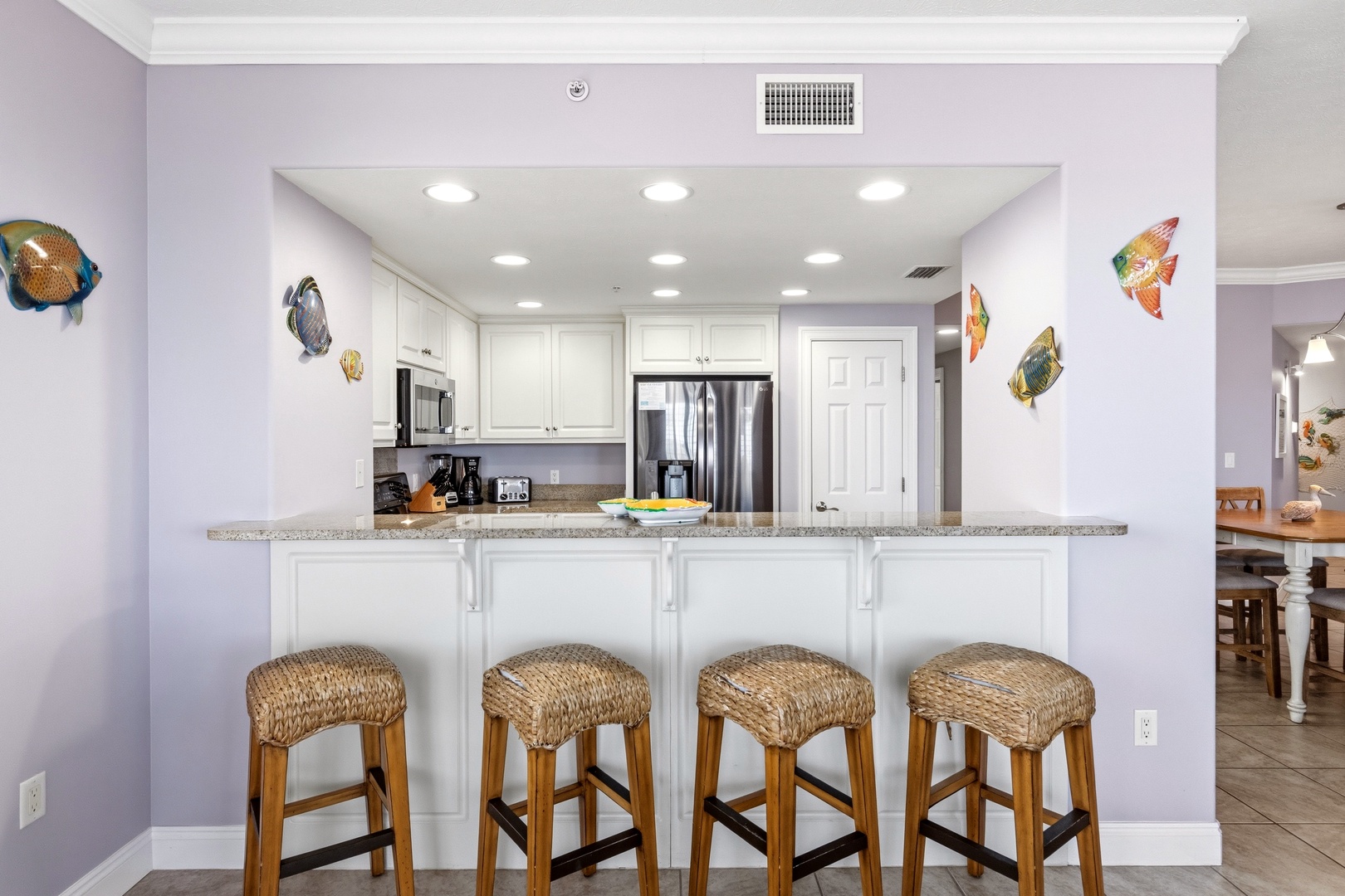 Your fully-equipped kitchen features granite countertops, stainless steel appliances, and a breakfast bar where you can enjoy morning coffee together.