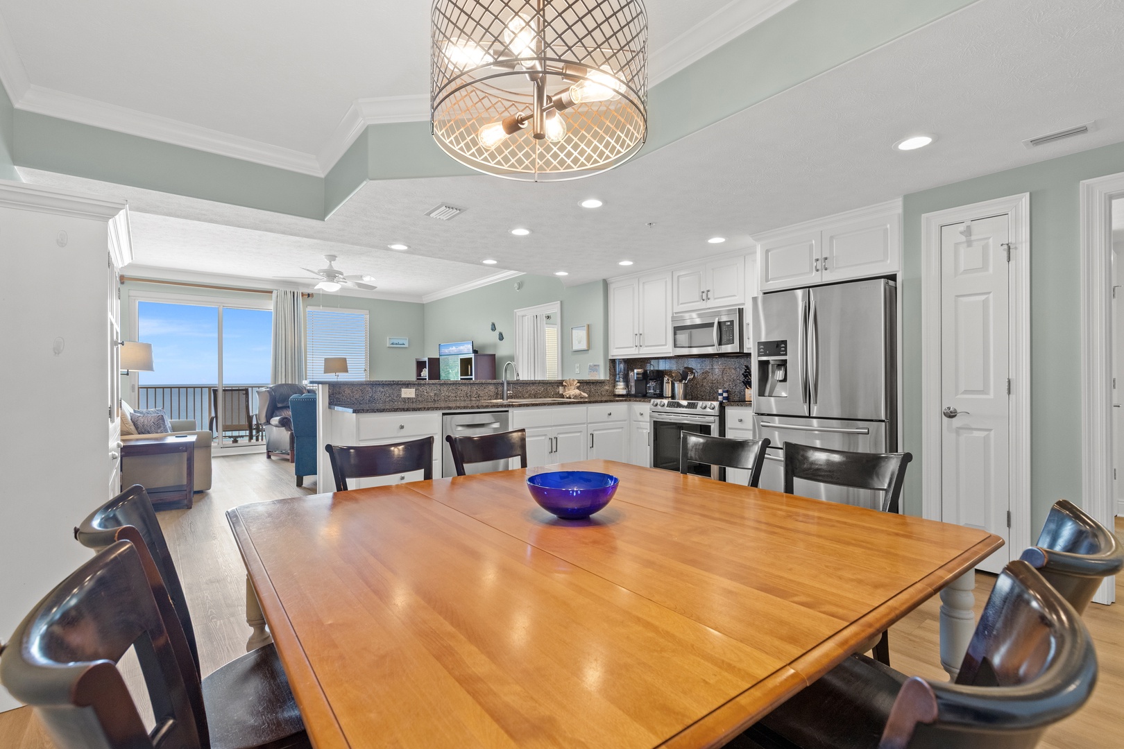 You'll love gathering around this spacious dining table while enjoying the open-concept kitchen and stunning ocean views from your balcony.