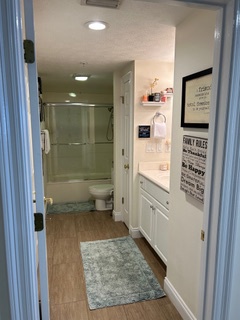 Step into your bright, modern bathroom featuring a spacious walk-in shower and thoughtful amenities for your comfort.