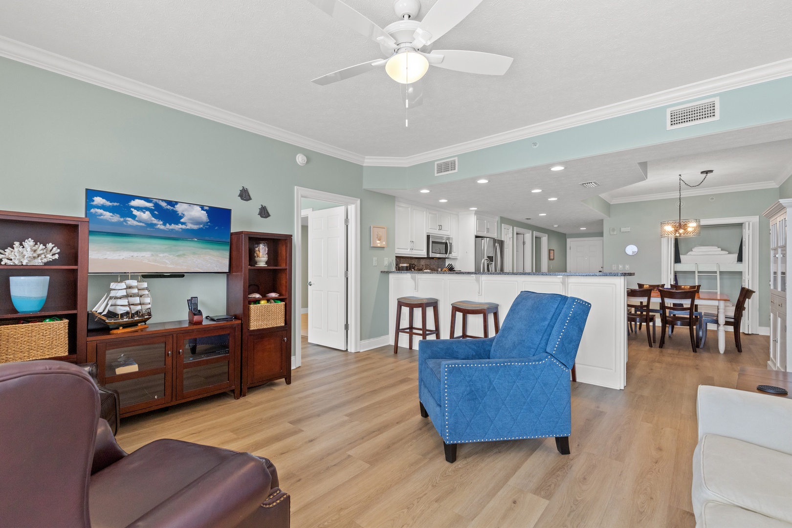 Relax in your bright open-concept living space with coastal decor, modern kitchen, and comfortable seating perfect for your getaway.