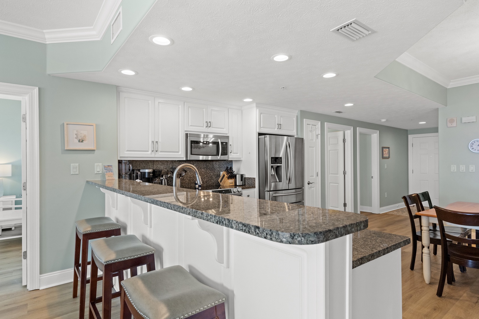 Your spacious kitchen features granite countertops, stainless steel appliances, and a breakfast bar where you can enjoy morning coffee.