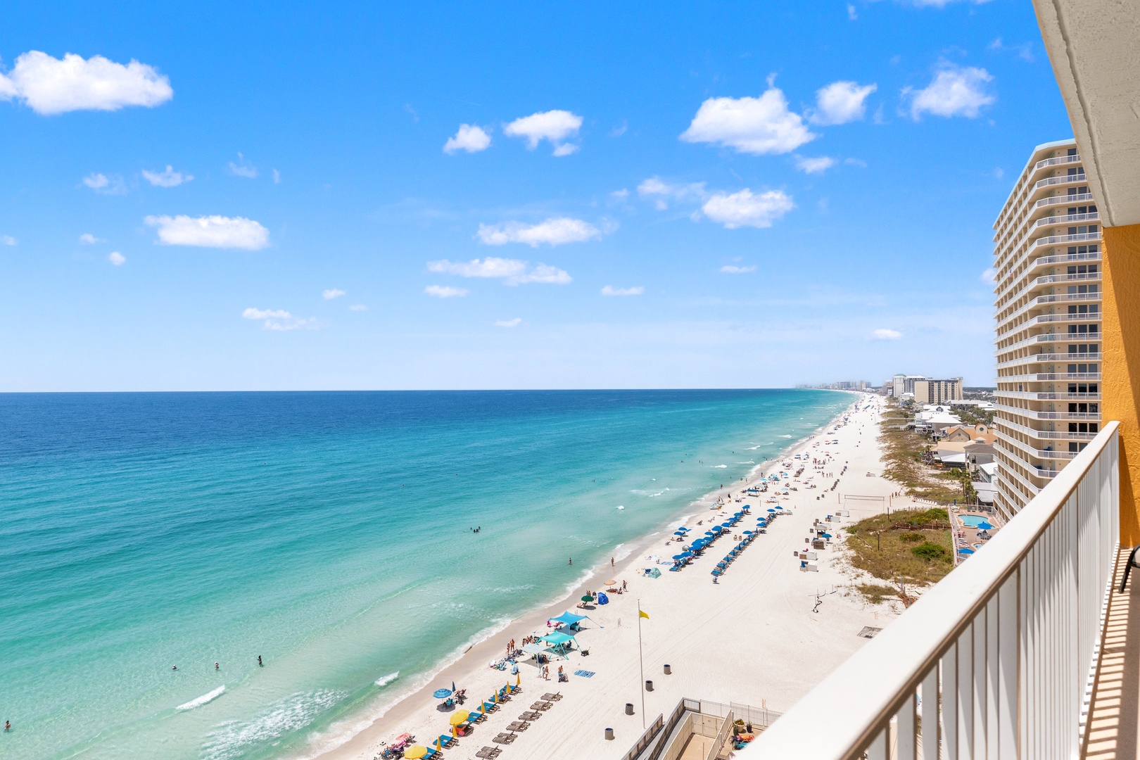 Beachfront paradise stretches before you—soft white sand, turquoise waves, and endless blue skies await your perfect coastal escape.