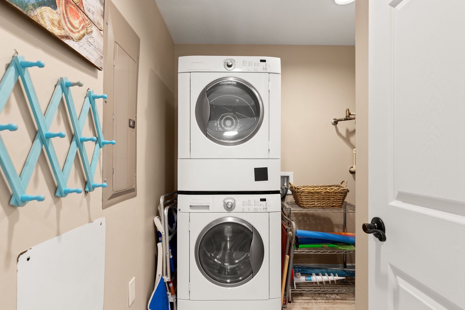 Your in-unit laundry makes it easy to pack light and stay fresh throughout your vacation, with a washer and dryer stacked conveniently beside organized shelving and a handy drying rack.