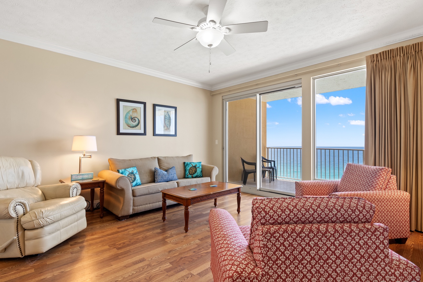 Imagine waking up to the stunning sea view framed by these sliding doors. Your spacious living room is designed for relaxation, with cozy seating and coastal breezes just steps away on your private balcony.