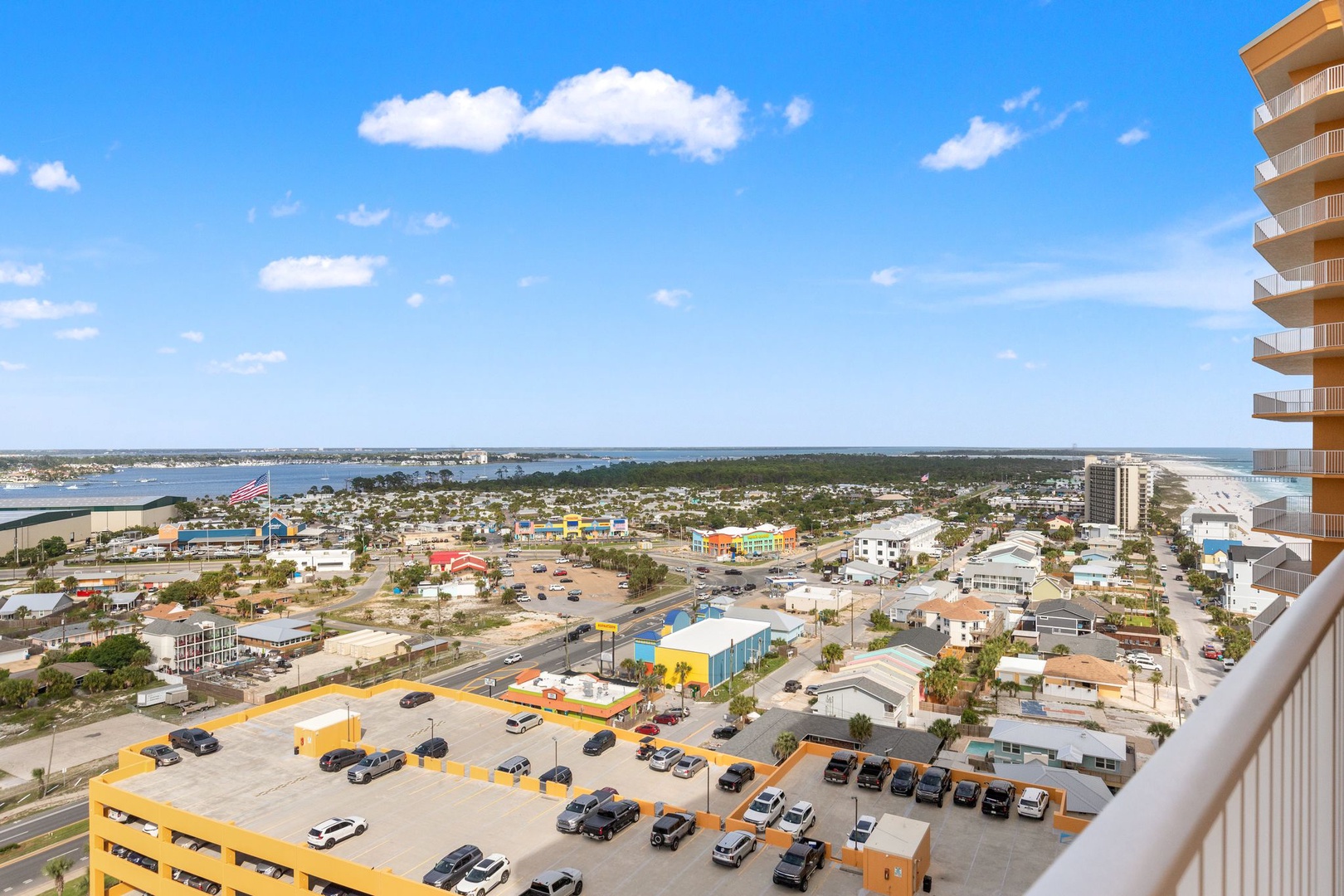 Aerial view showcasing the coastal community with nearby beaches, waterways, and local attractions. The property is part of a vibrant beachfront neighborhood with convenient access to dining, entertainment, and sandy shores.
