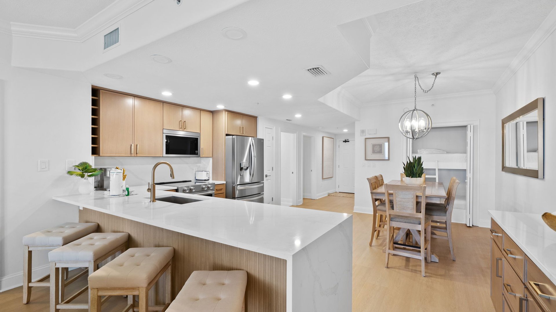 Your spacious kitchen gleams with modern elegance, featuring a pristine marble island perfect for morning coffee or evening conversation.