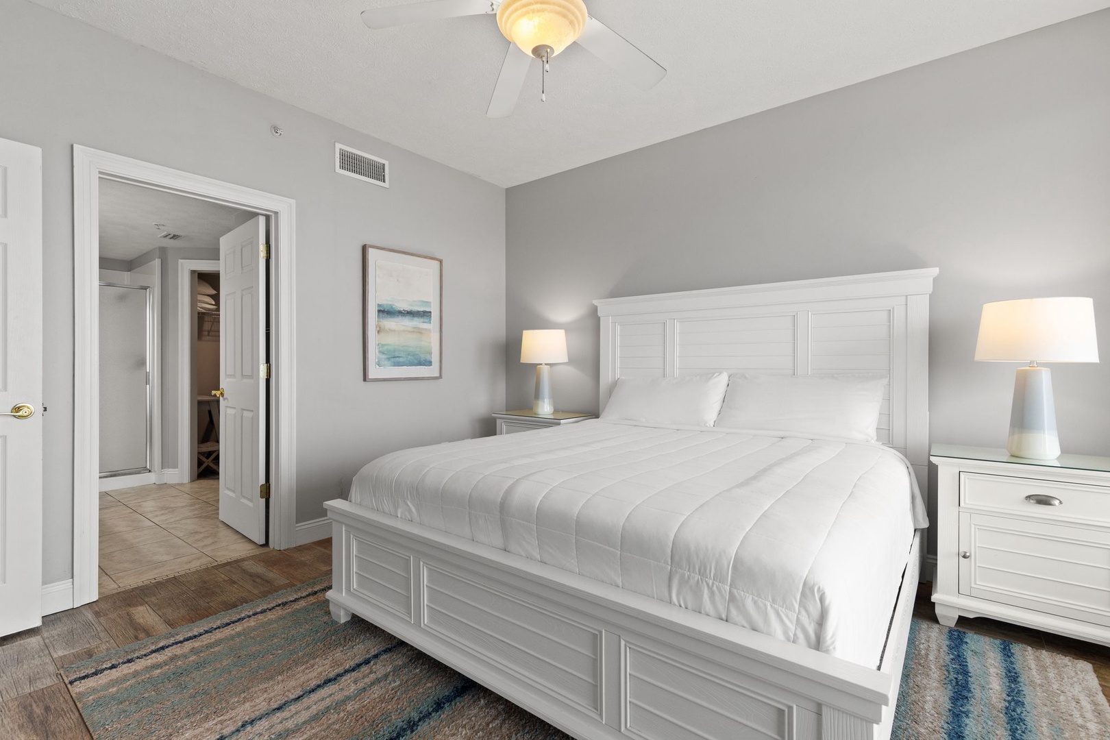 Sink into plush bedding and unwind in your serene retreat, where soft coastal tones and gentle lighting create the perfect atmosphere for restful nights and lazy mornings.