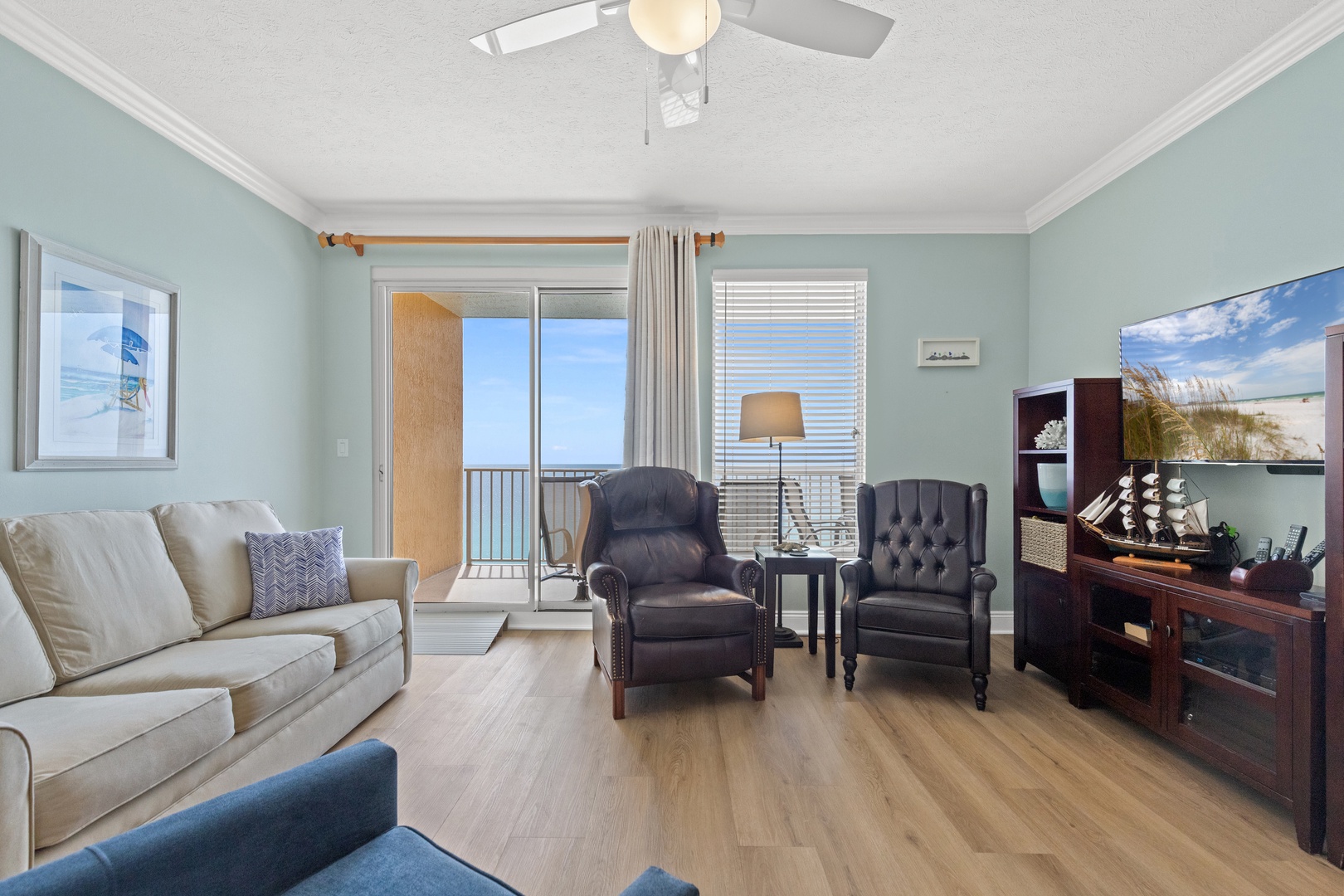 Relax in your spacious living room with plush seating and breathtaking ocean views from your private balcony.