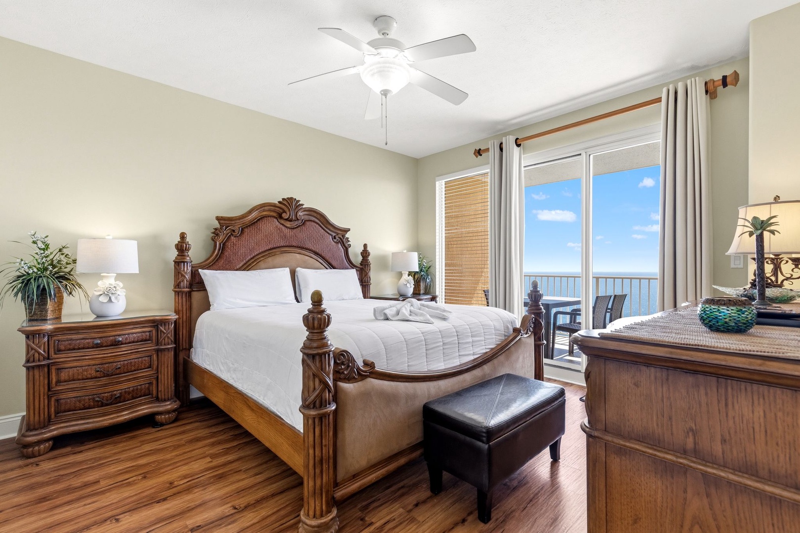 Wake up to endless ocean views from your elegant bedroom, where rich wood furnishings and crisp linens create the perfect coastal retreat.