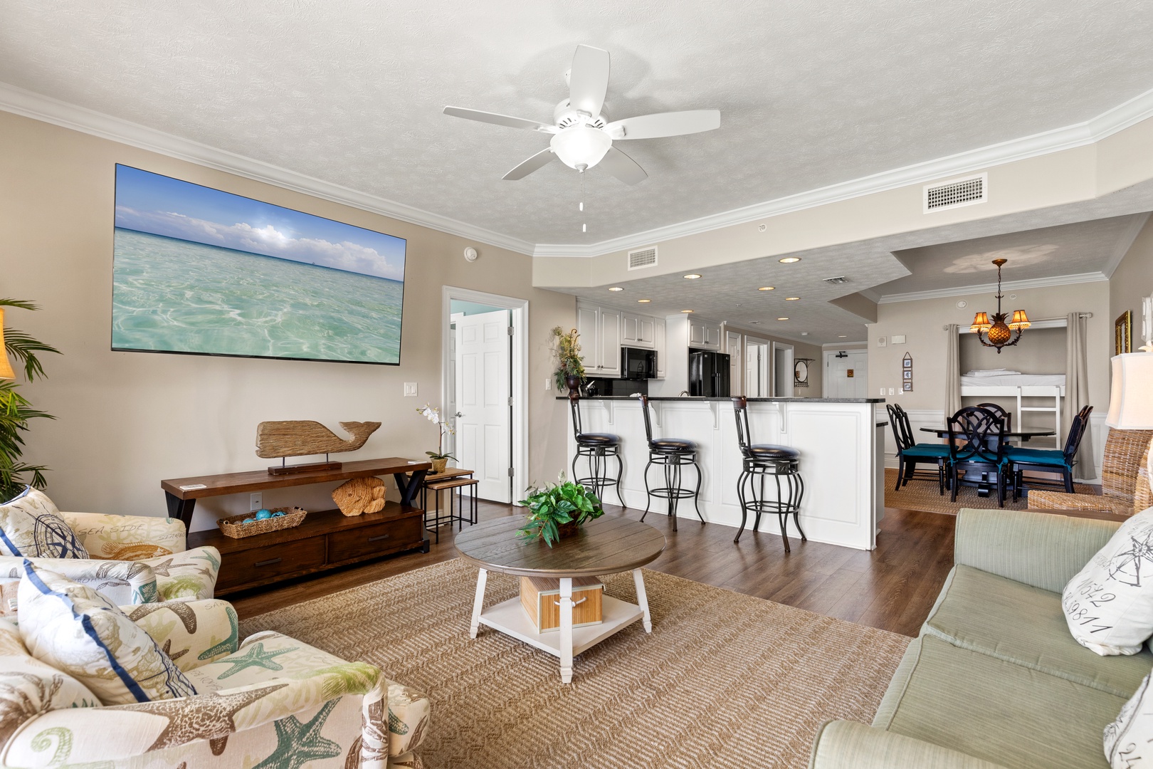 Relax in your coastal haven with ocean views, comfortable seating, and an open kitchen perfect for vacation memories.