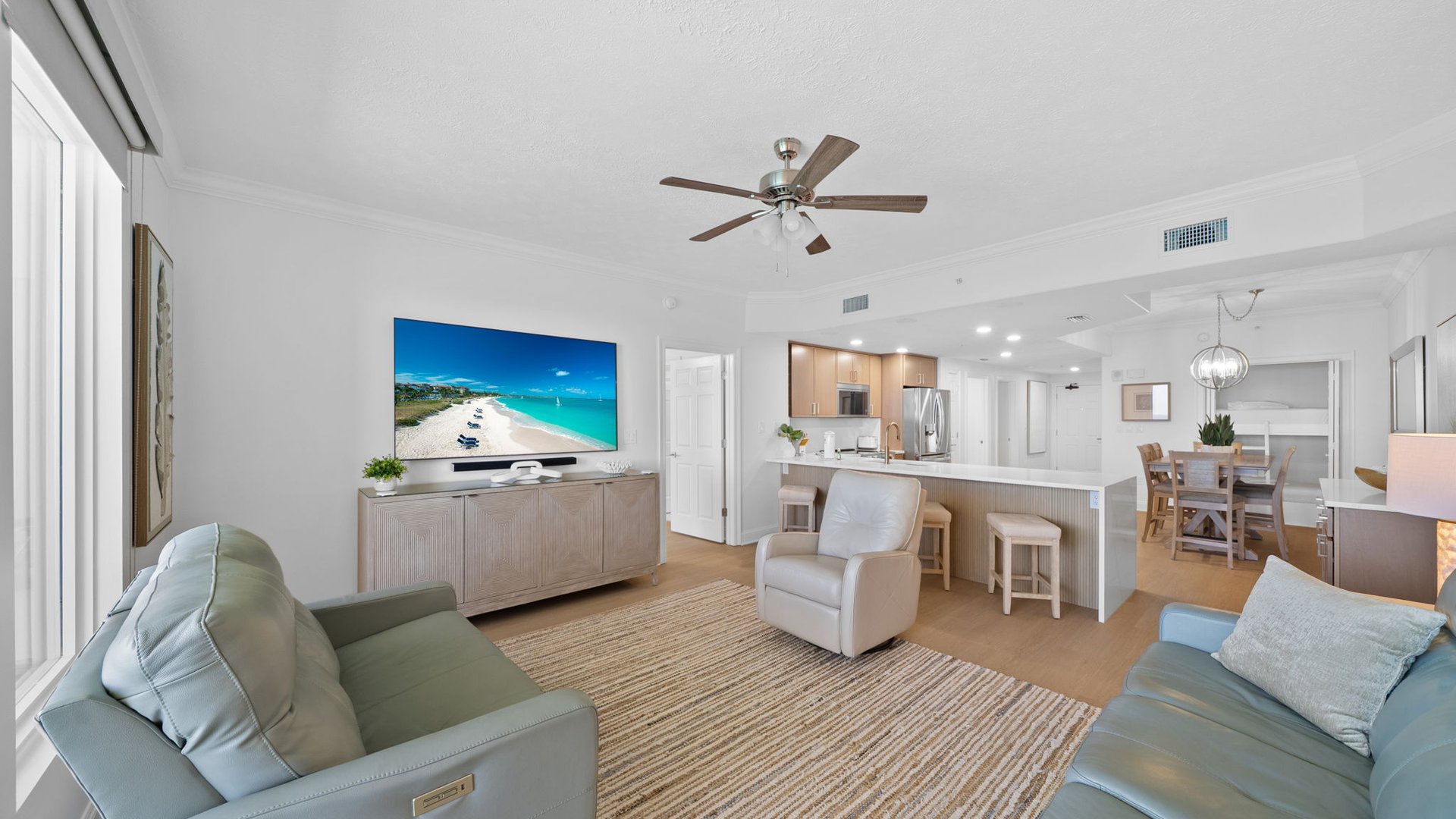 Unwind in this bright, modern living space with comfortable seating, large TV, and open kitchen perfect for your vacation retreat.