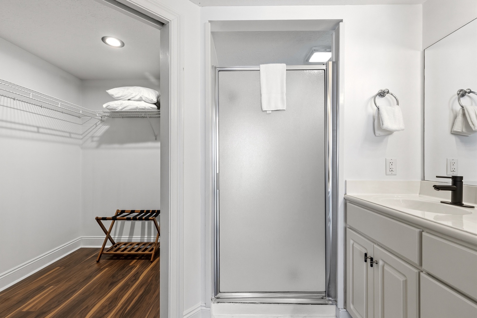 Step into your pristine ensuite where thoughtful design meets comfort. Fresh towels await while ample closet space keeps your belongings organized throughout your stay.