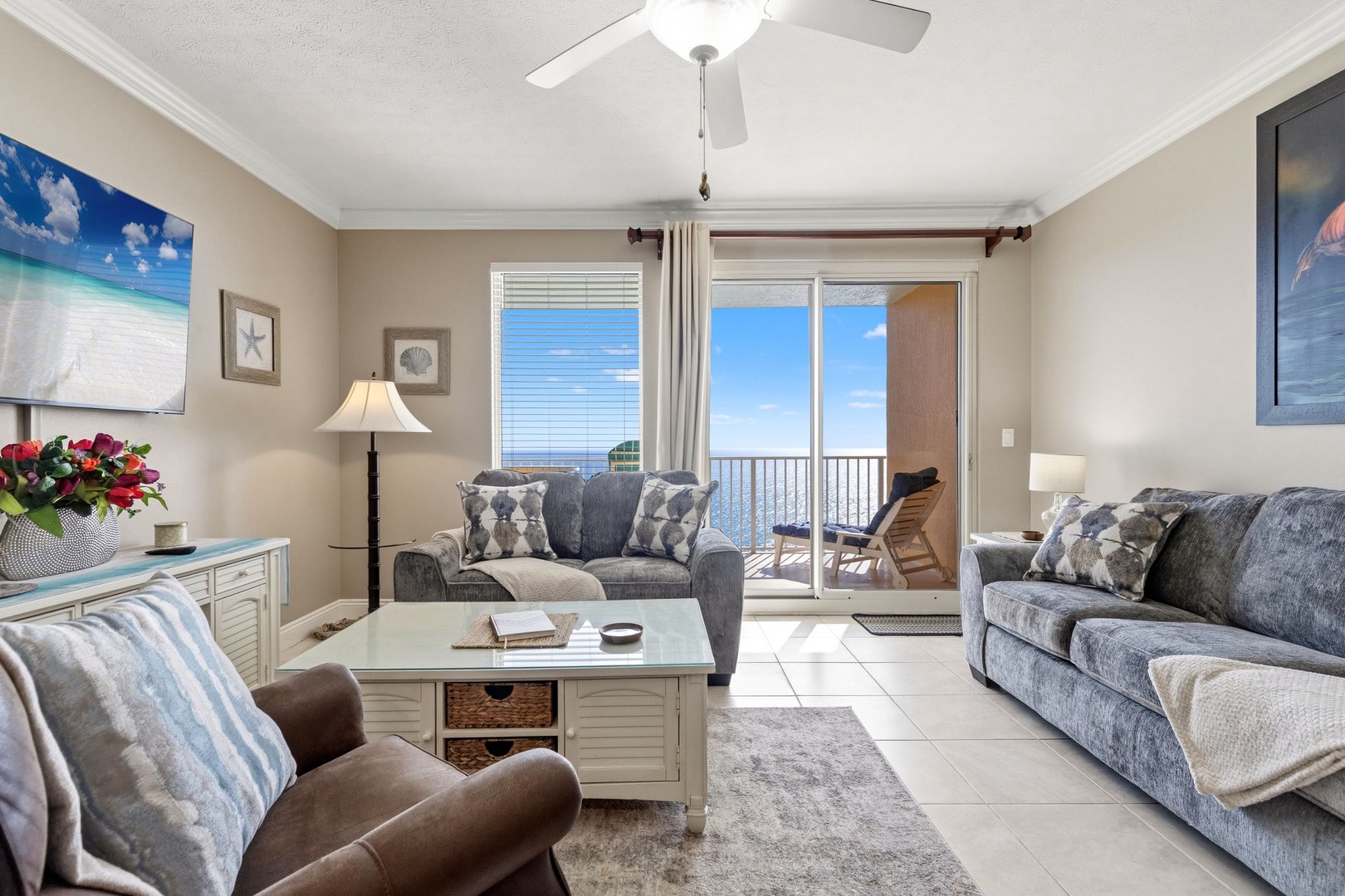 Sink into plush sofas while ocean breezes flow through your private balcony doors, creating the perfect coastal retreat for relaxation.