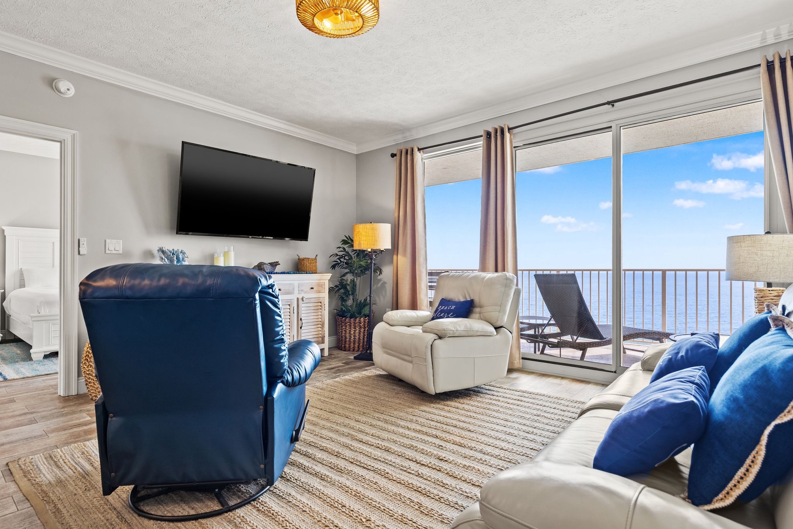 Sink into plush seating and soak up stunning sea views through your expansive balcony doors. Coastal-chic décor, warm textures, and a flat-screen TV create your perfect beachside retreat.