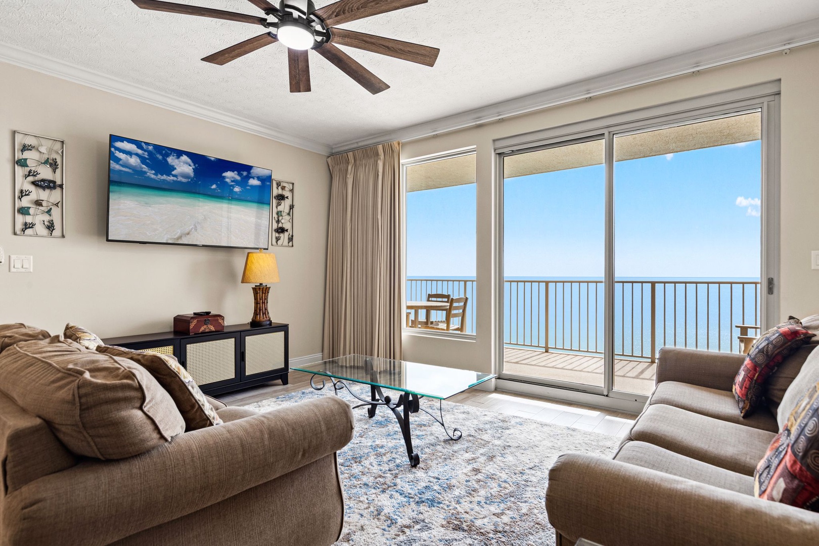 Your oceanfront living room features comfortable seating and floor-to-ceiling windows revealing stunning sea views from your private balcony.