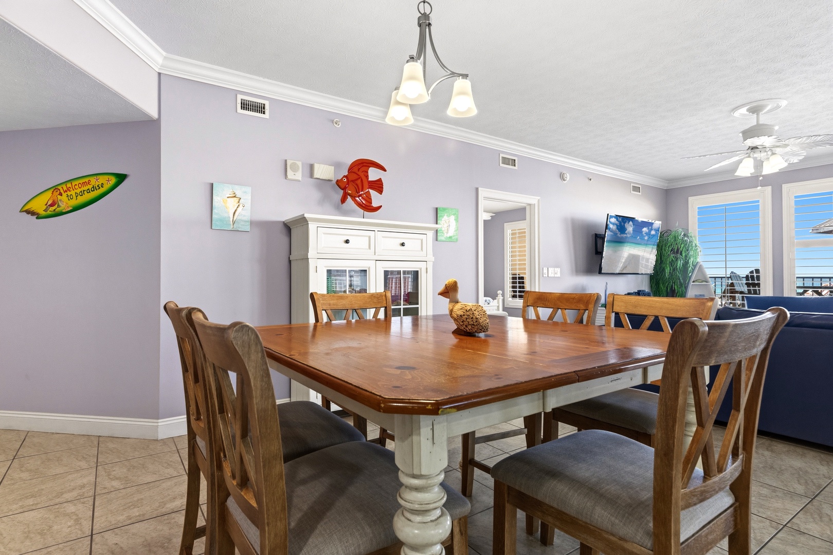 Gather around this spacious dining table where your group can enjoy meals together while admiring coastal views through expansive windows.