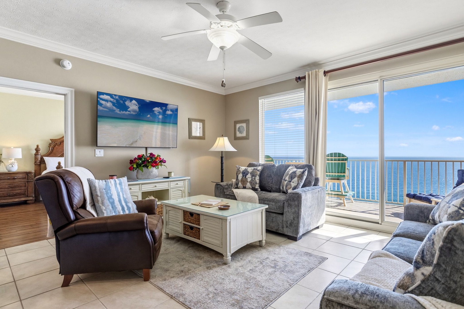 Your oceanfront living room offers breathtaking sea views through floor-to-ceiling windows, with plush seating and coastal decor creating the perfect retreat.