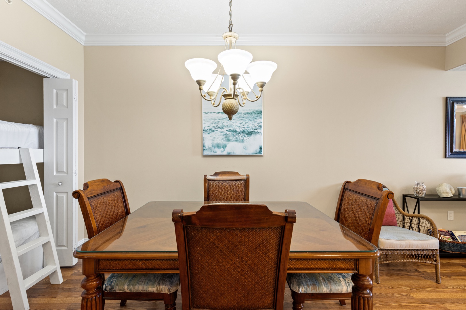 Gather around this inviting dining table for shared meals and memories. The elegant chandelier sets a warm tone for your time together.