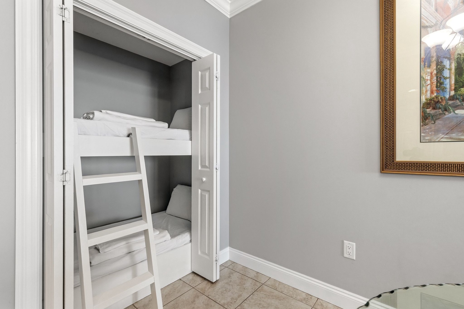 Your cozy built-in bunk bed nook offers comfortable sleeping with crisp white linens and thoughtful design details.