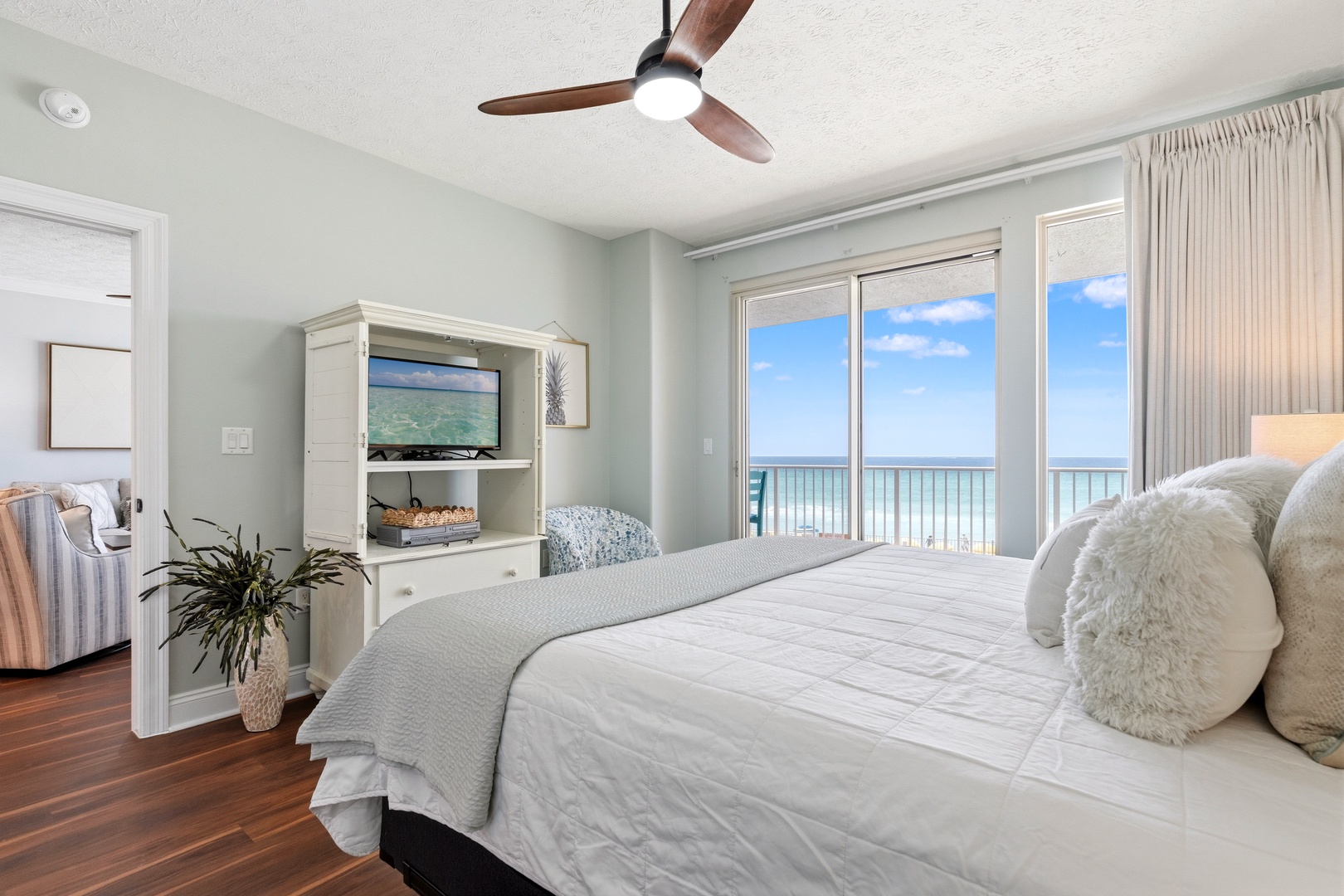 Wake up to endless ocean views through your private balcony doors, with plush bedding and modern amenities creating your perfect beachfront retreat.