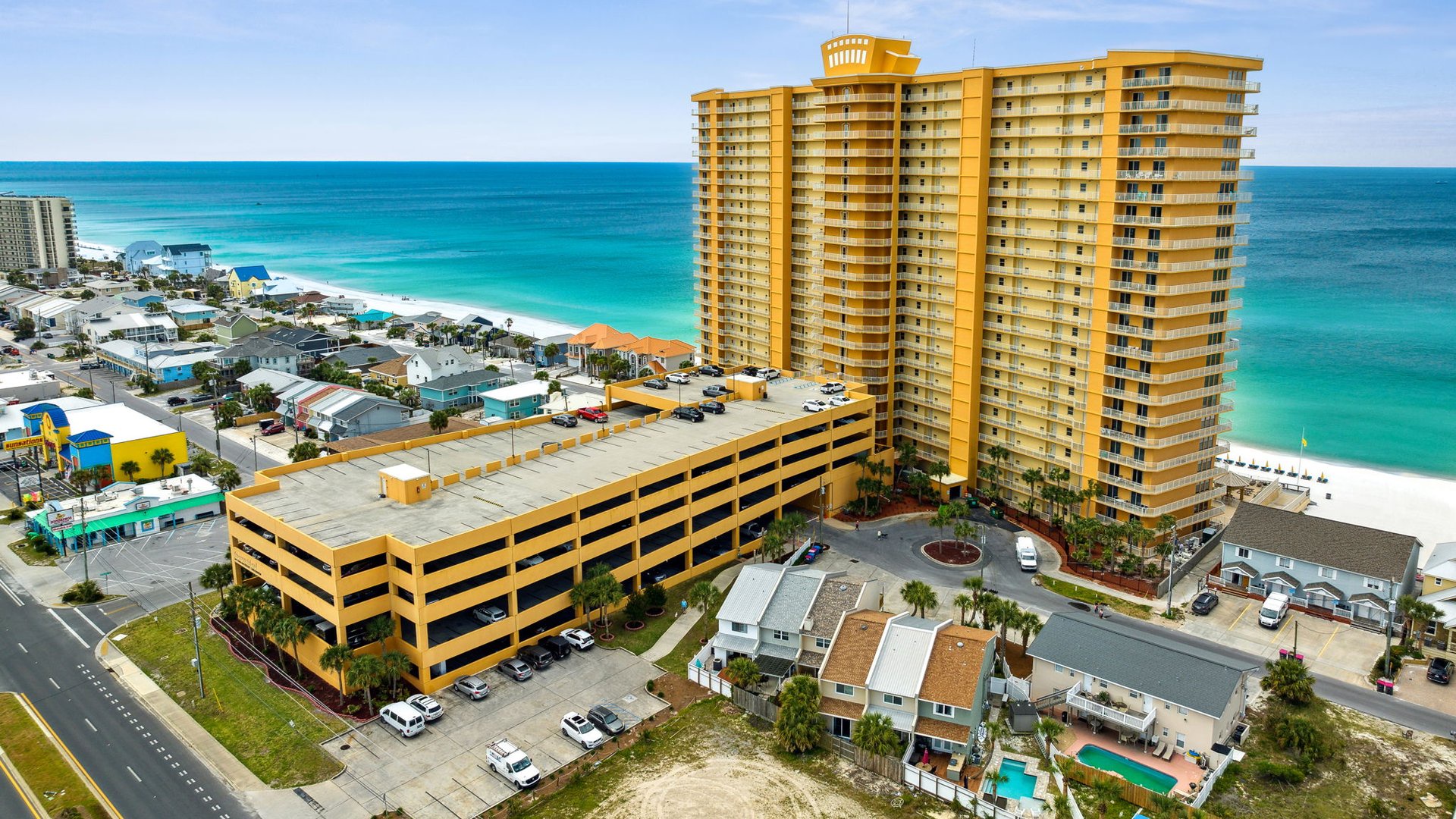 Towering beachfront resort with stunning ocean views, just steps from pristine turquoise waters and white sand beaches.