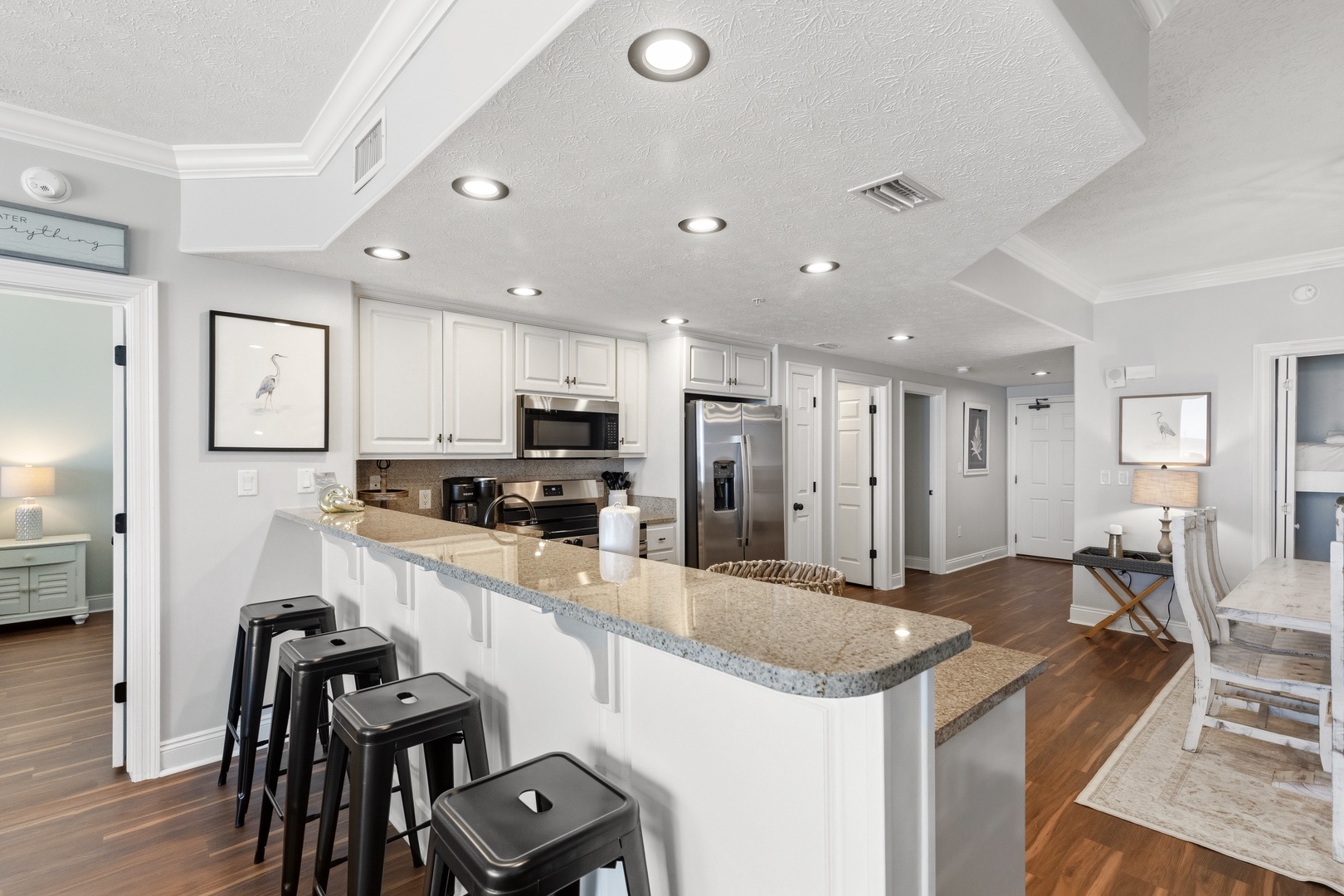 Your fully-equipped kitchen features granite countertops, stainless appliances, and a breakfast bar where you can sip morning coffee or gather with friends.