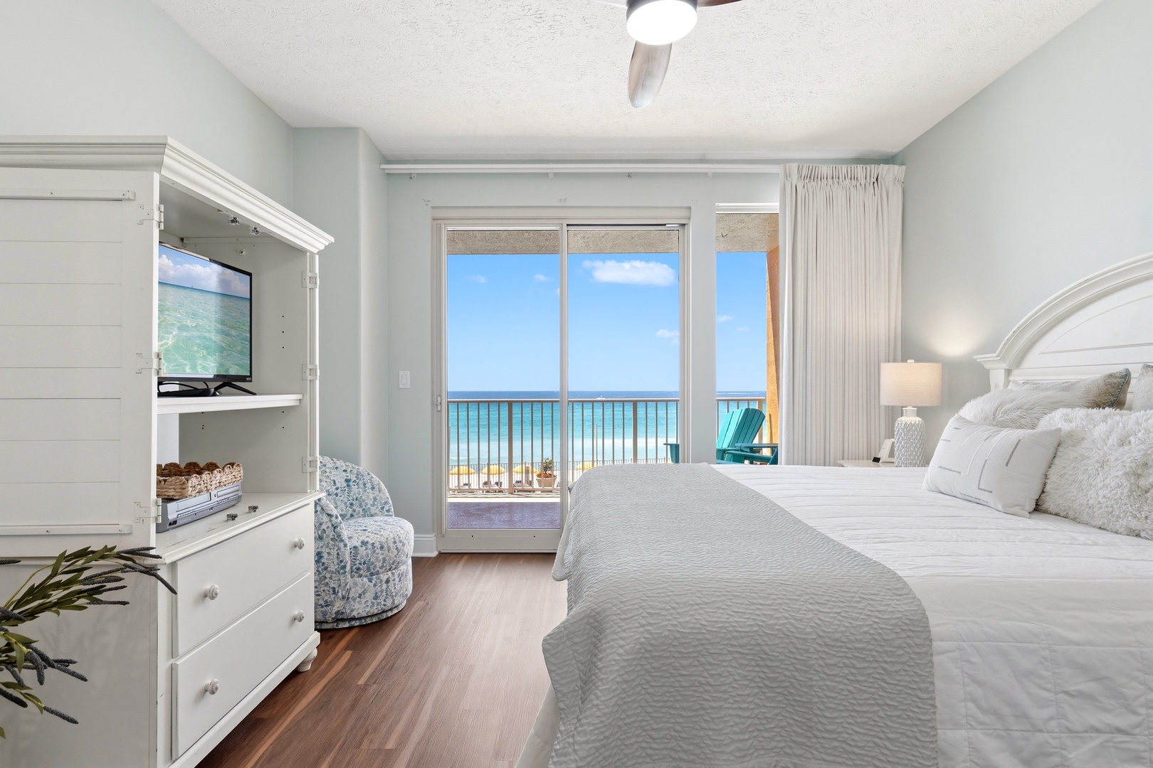 Wake up to stunning ocean views from your serene bedroom, where soft coastal colors and luxurious linens create the perfect seaside retreat.
