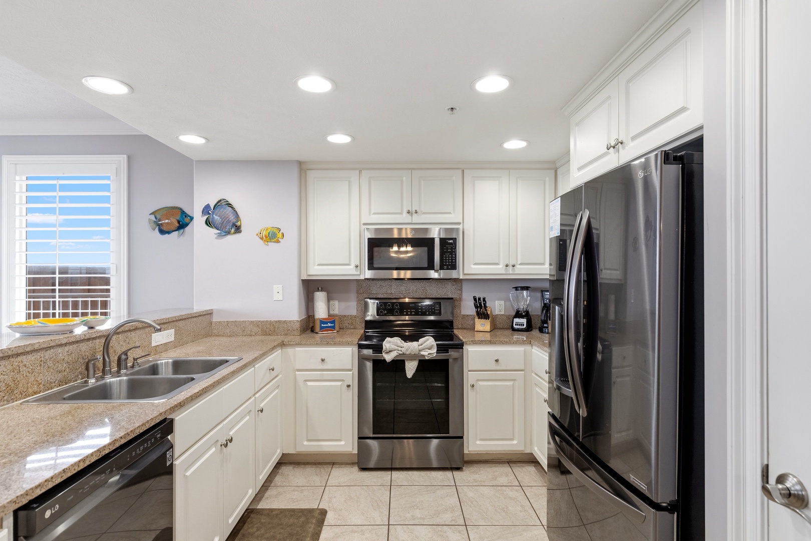 Cook your favorite meals in this bright, fully equipped kitchen with granite counters and stainless steel appliances.