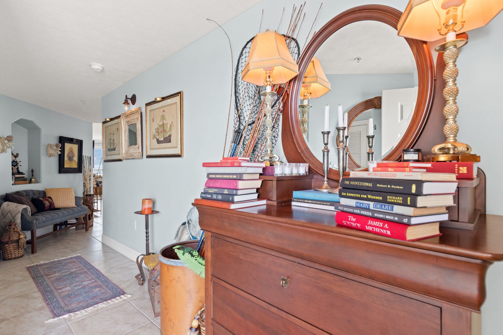 Step into an elegantly styled living space where coastal charm meets thoughtful design. Warm light from unique lamps invites you to relax, while curated books and personal touches make this your home away from home.