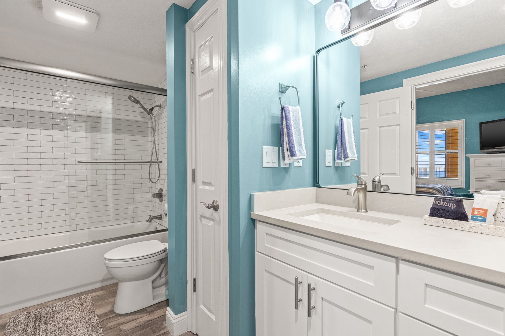 Refresh and unwind in your bright, coastal-inspired bathroom with modern fixtures, crisp tilework, and plenty of counter space for a comfortable stay.