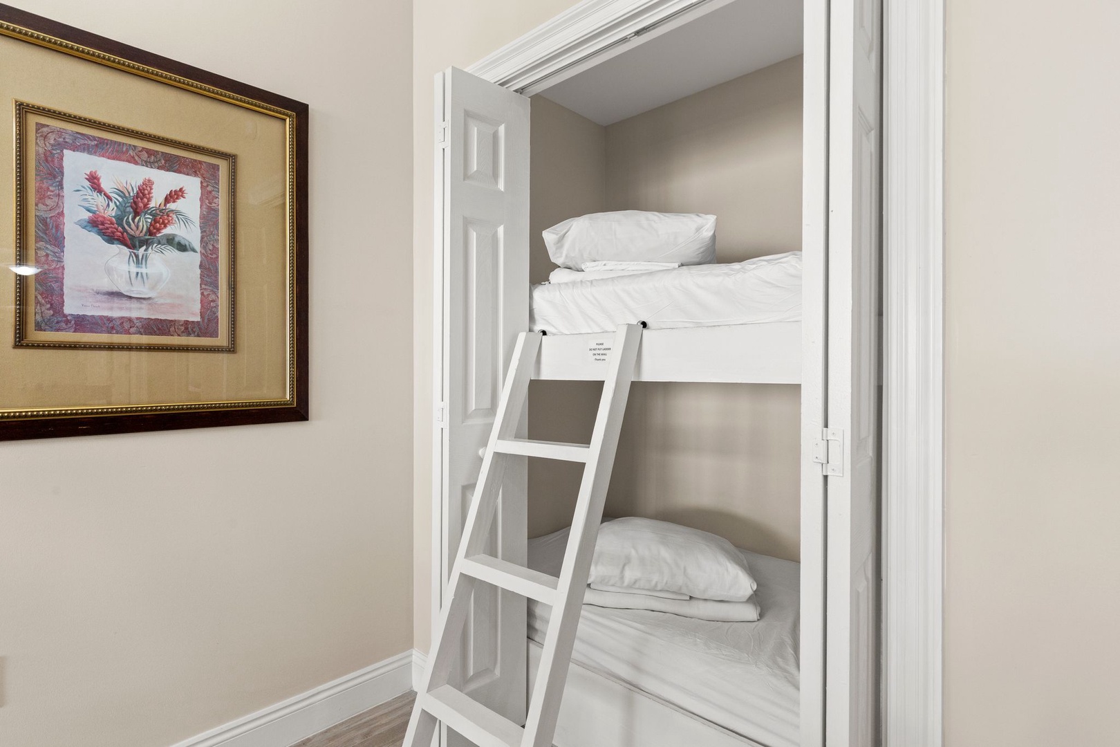 Your kids will love this cozy built-in bunk nook! Fresh white linens and a sturdy ladder create the perfect hideaway for adventurous sleepers.