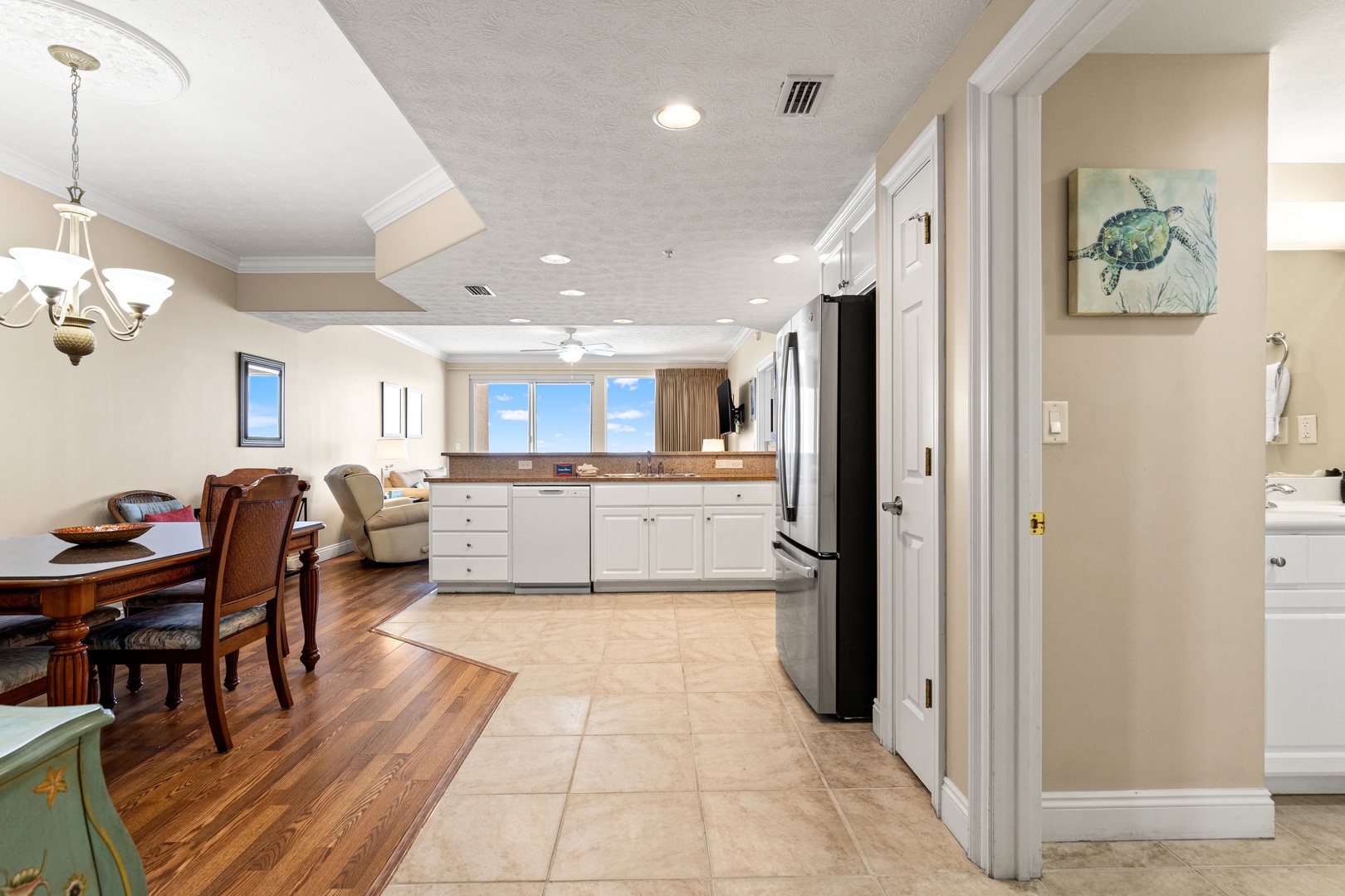 Step into your bright, open-plan living space with a fully equipped kitchen, dining area, and cozy lounge—perfect for gathering, cooking, and unwinding after a day at the beach.