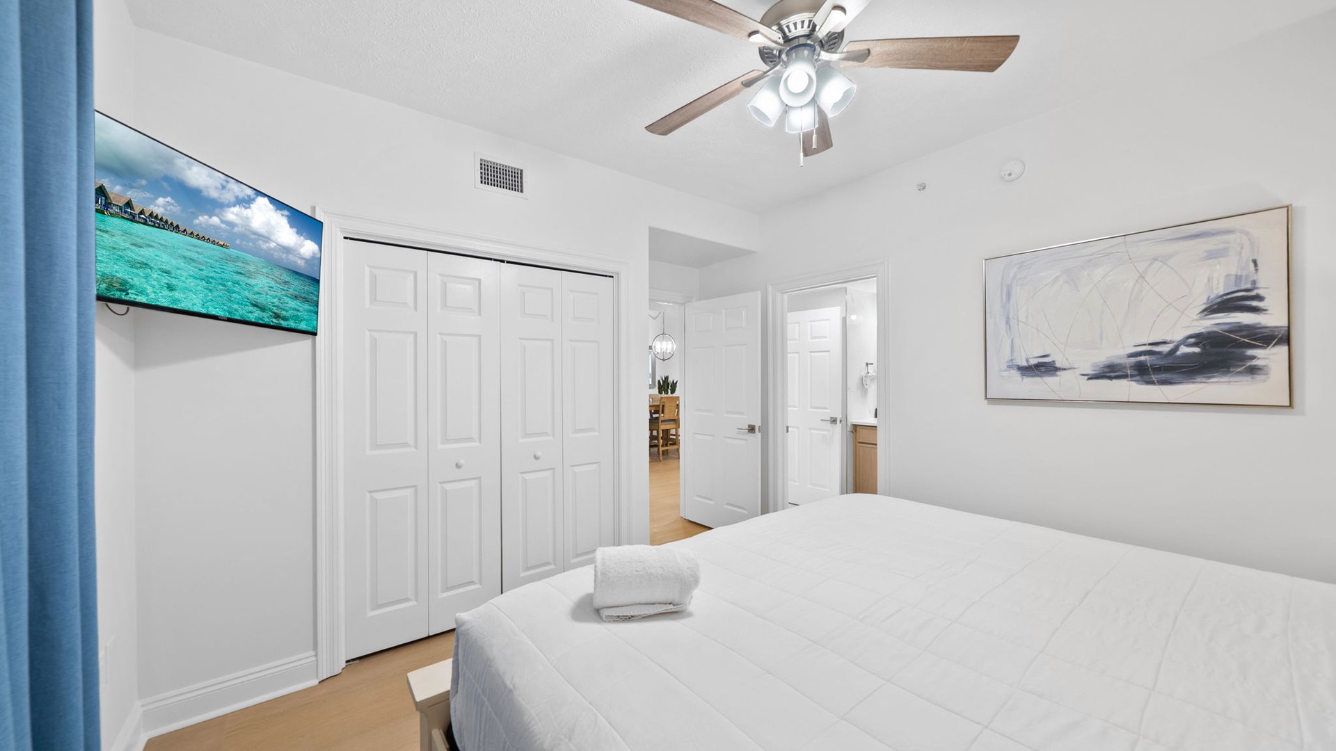 Unwind in your bright bedroom featuring a comfortable bed, ceiling fan, flat-screen TV, and ample closet space for all your vacation essentials.