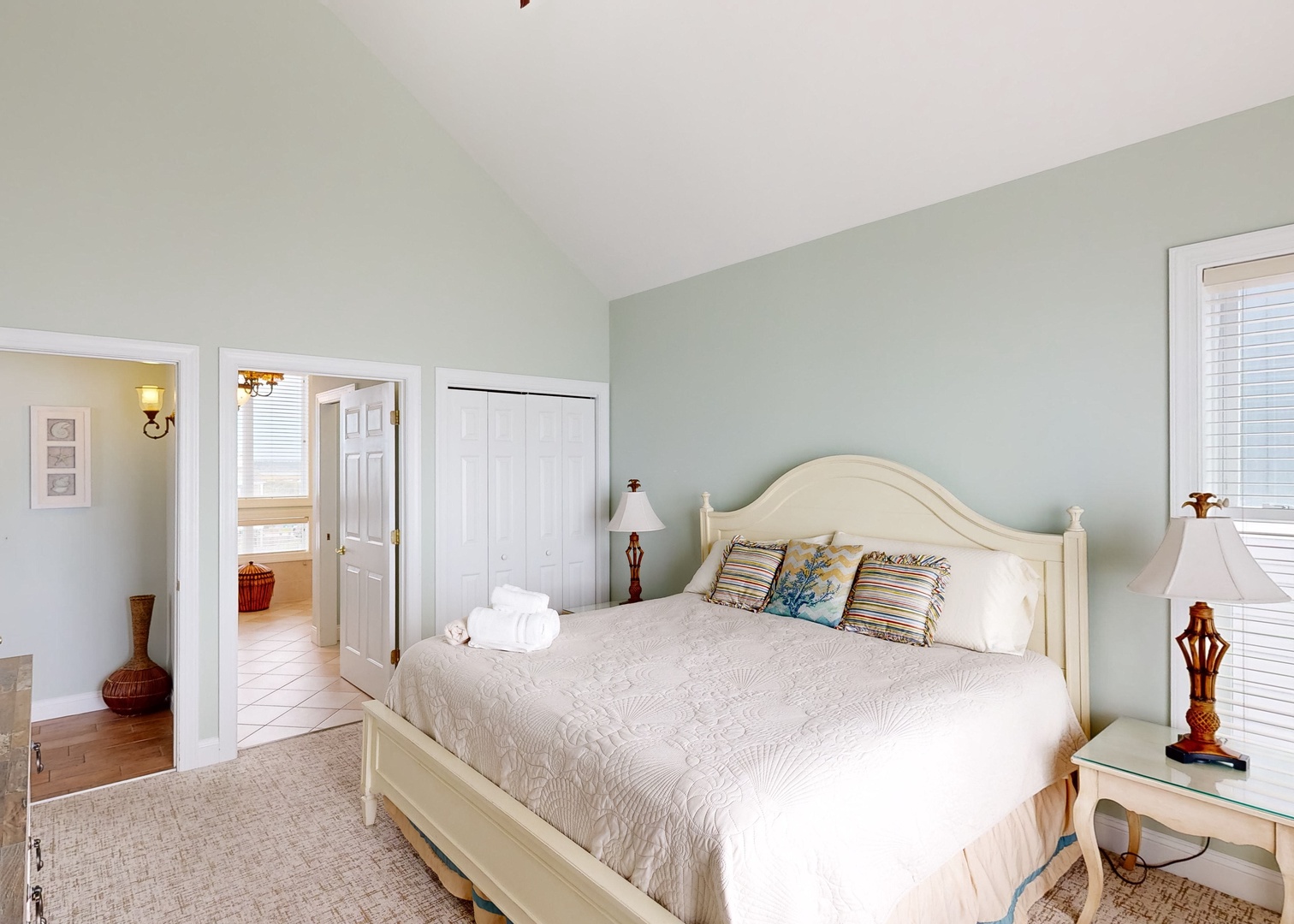 Slip into your peaceful retreat with vaulted ceilings and soothing coastal hues. Fresh linens and bedside lamps await, while soft natural light fills your private sanctuary.
