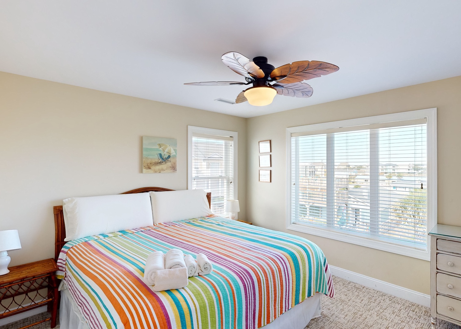 Drift off beneath a tropical ceiling fan and wake to bright coastal light streaming through the windows—your beachside retreat awaits.