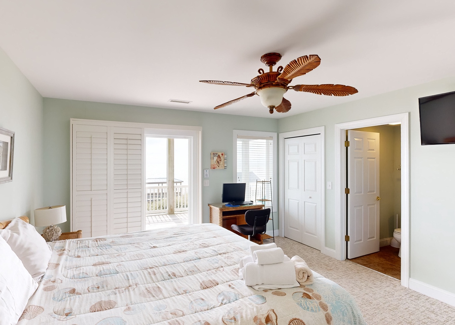 Wake up to soft coastal tones and breezy comfort in your serene bedroom retreat. With a private balcony beckoning just beyond the shutters, you'll love starting each morning with fresh air and peaceful views.