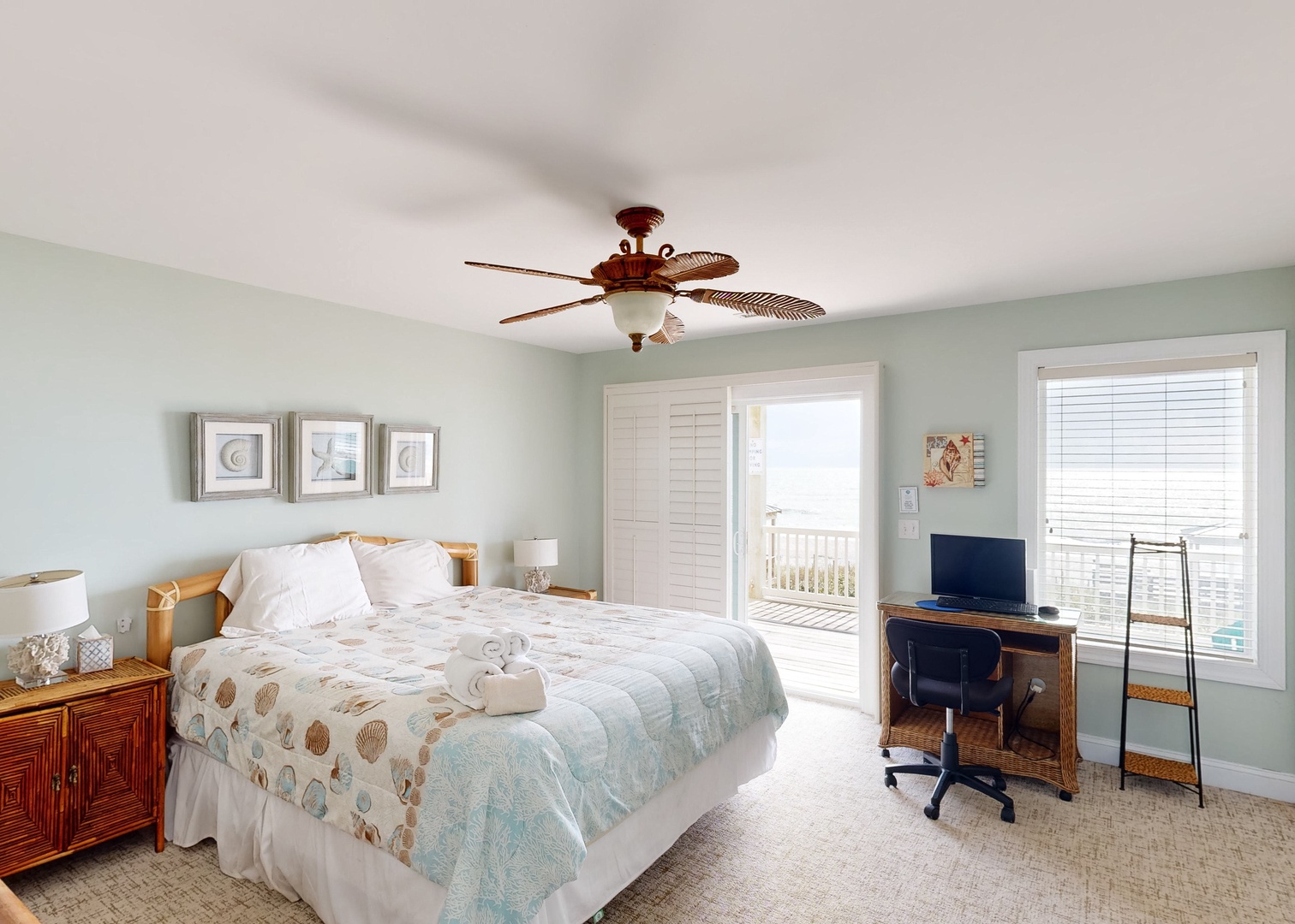 Your coastal bedroom retreat awaits with soothing sea-inspired tones, a plush bed, and direct access to your private balcony with ocean views.