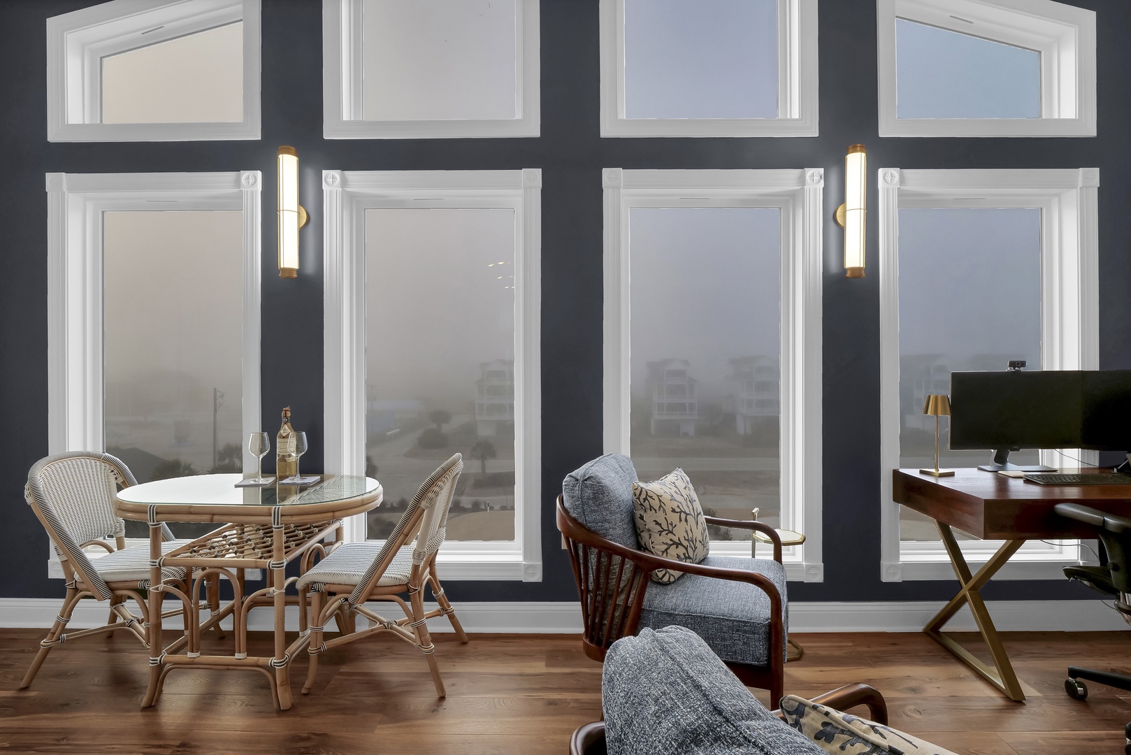 Settle into your cozy living space with floor-to-ceiling windows framing sweeping views of the coastline. Sip wine at your bistro table or unwind in the plush armchair as daylight softens into evening.