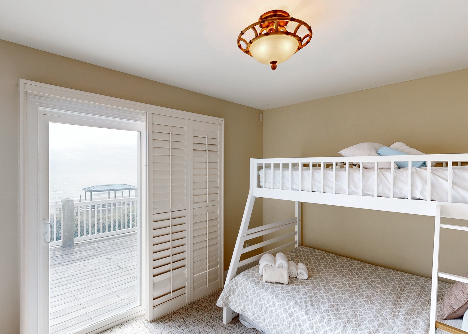 Your cozy bunk room opens right onto your private deck overlooking the ocean—wake up to sea breezes and endless coastal views just steps away.
