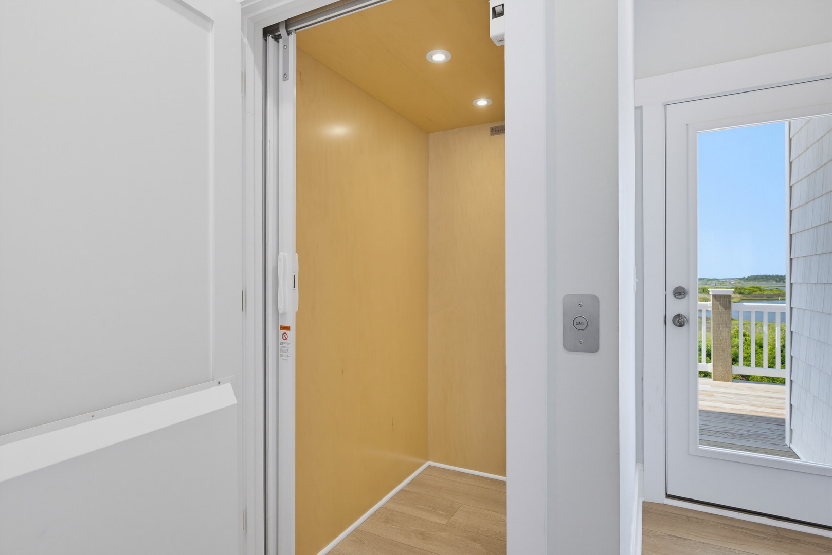 Easy access throughout your stay with a modern elevator connecting all levels, plus scenic views through the glass door.